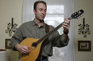 Charlie Zahm plays a bouzouki at his Coatesville home. Since he was a youngster, he has been taken by bluegrass and folk music. &quot;I love the traditional aspect of folk songs,&quot; Zahm says. &quot;The stories are timeless - songs of love, loss, exploration and adventure.&quot;
